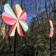 Detail of two of the 4’ x 4’ x 10’ aluminum pinwheels in a kaleidoscope of colors that flank the two lane road of the Plaza Shamrock Neighborhood bridge in Charlotte, NC.